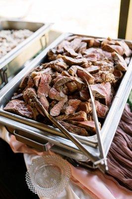 sliced NY strip steak - the red meat option at my buffet wedding - perfectly cooked to rare/medium rare!