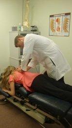 Dr Bahr administering a chiropractic spinal adjustment