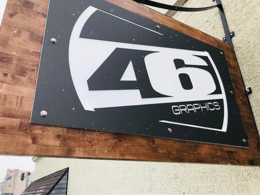 Brushed metal on stained butcher block with a backlight logo creates a classic cool look.