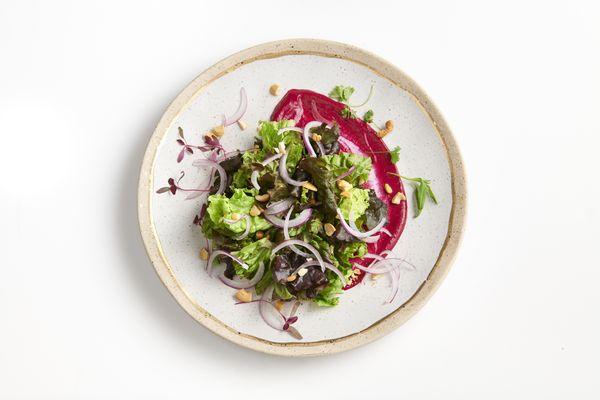 Baby greens on top of a beet & yogurt puree with crumbled cashews, pickled red onions and lemon honey vinaigrette.