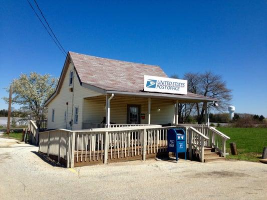 Front with stairs and a ramp to the left that provides wheelchair and disability access.