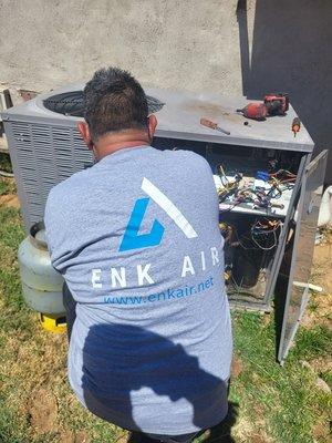 Enk air  technician out working on customer unit in mesa.