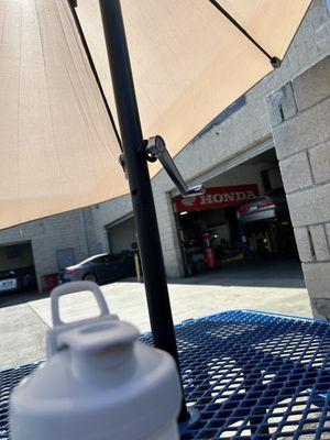 A table and bench with umbrella so you can wait.