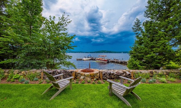 Fieldstone fire pit built into existing stone retaining wall