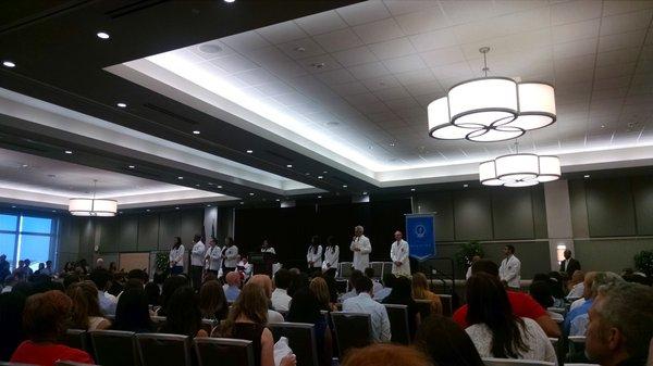 Students receiving their jackets from second year students.