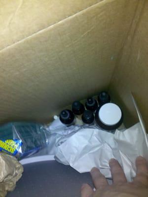 Tiny glass dropper bottles stuck in the bottom of a large box w/no padding whatsoever..