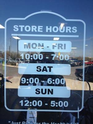 Store hours posted outside the shop