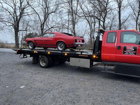 Classic car tied down with straps so no damage to powder coating from chains