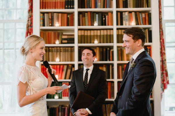 A couple gets married in the library in one of our estate homes. Photo courtesy of Lev Kuperman Photography.